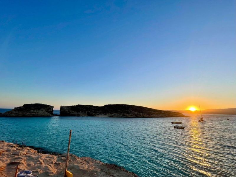 Sunset Cruise Malta - Aerial view of a tour boat over crystal-clear waters and visible seabed off Malta's coast