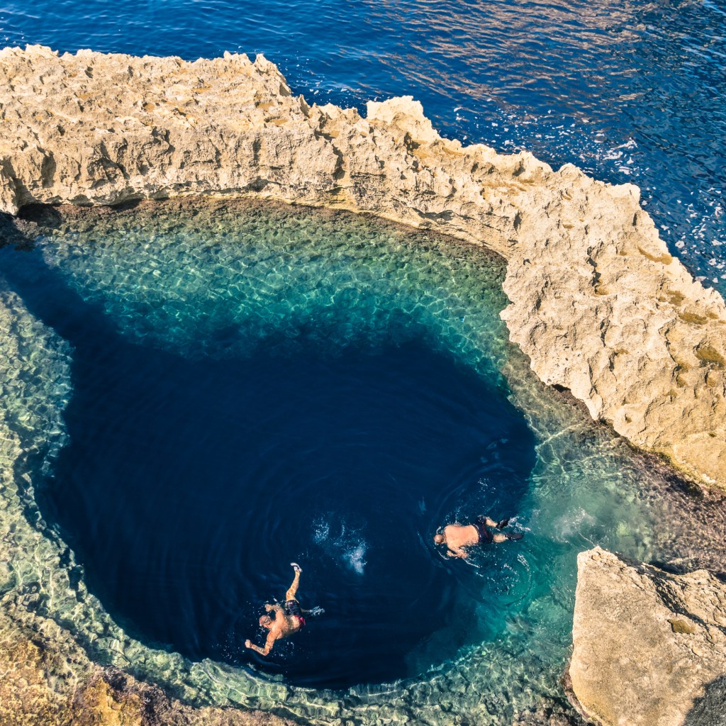Gozo boat tours passing the Blue Hole and dramatic rocky coastline