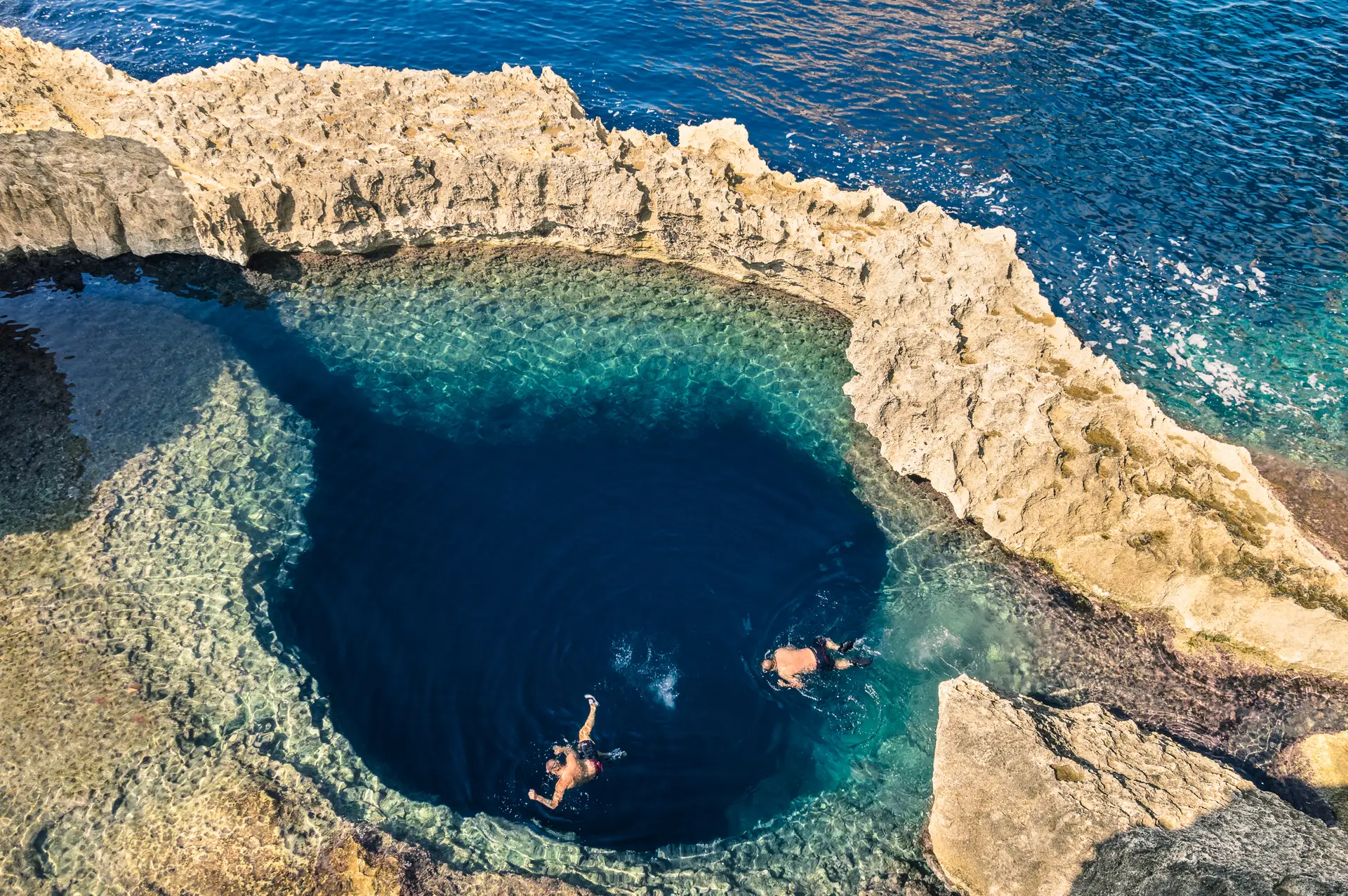 View of Gozo’s Blue Hole and rocky coastline from the sea