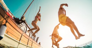 party boat Malta - sunset in the Mediterranean waters with guests dancing and lights reflecting on the sea